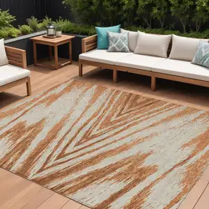 Photo of Orange Brown And Beige Abstract Washable Indoor Outdoor Area Rug