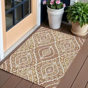 Photo of Orange Gold And Ivory Floral Washable Indoor Outdoor Area Rug