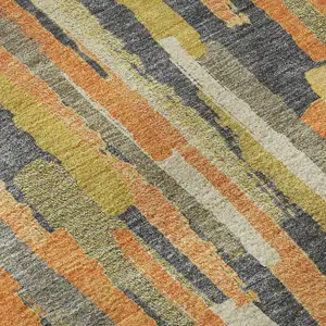 Photo of Orange Gold And Ivory Striped Washable Area Rug With UV Protection