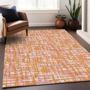 Photo of Orange Pink And Beige Abstract Washable Indoor Outdoor Area Rug