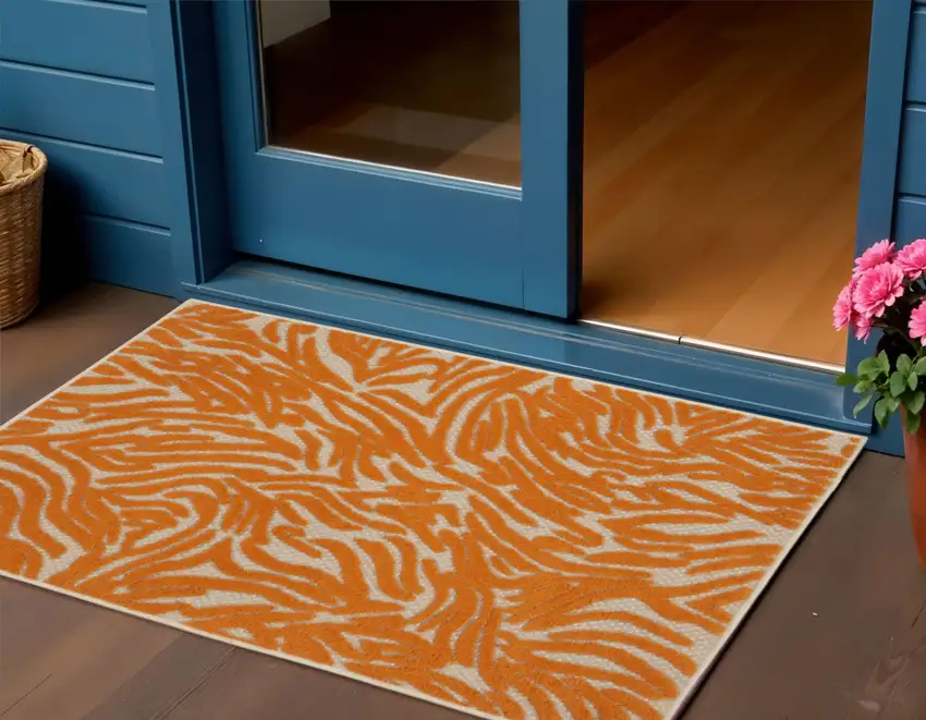 Orange And Ivory Abstract Indoor Outdoor Area Rug Photo 1
