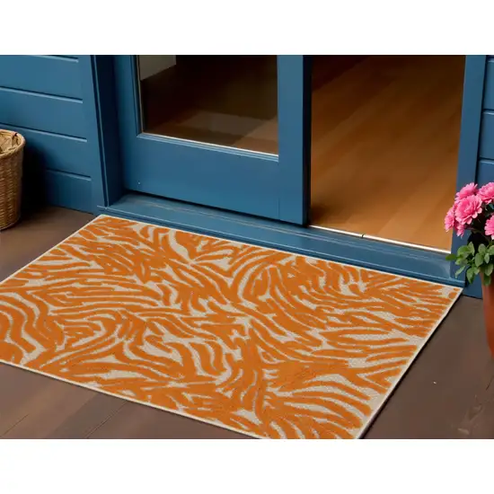 Orange And Ivory Abstract Indoor Outdoor Area Rug Photo 1