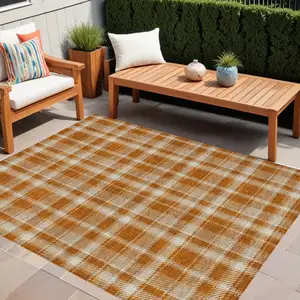 Photo of Orange and Ivory Plaid Washable Non Skid Indoor Outdoor Area Rug