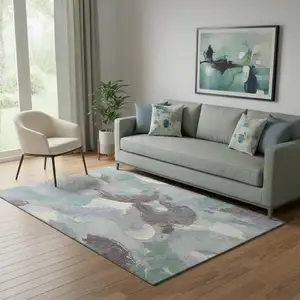 Photo of Pale Aqua Brown And Ivory Abstract Washable Area Rug With UV Protection