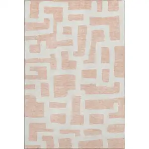 Photo of Peach And Ivory Abstract Geometric Washable Area Rug With UV Protection