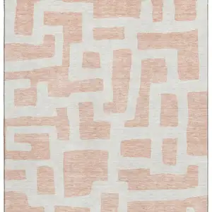 Photo of Peach And Ivory Abstract Geometric Washable Area Rug With UV Protection