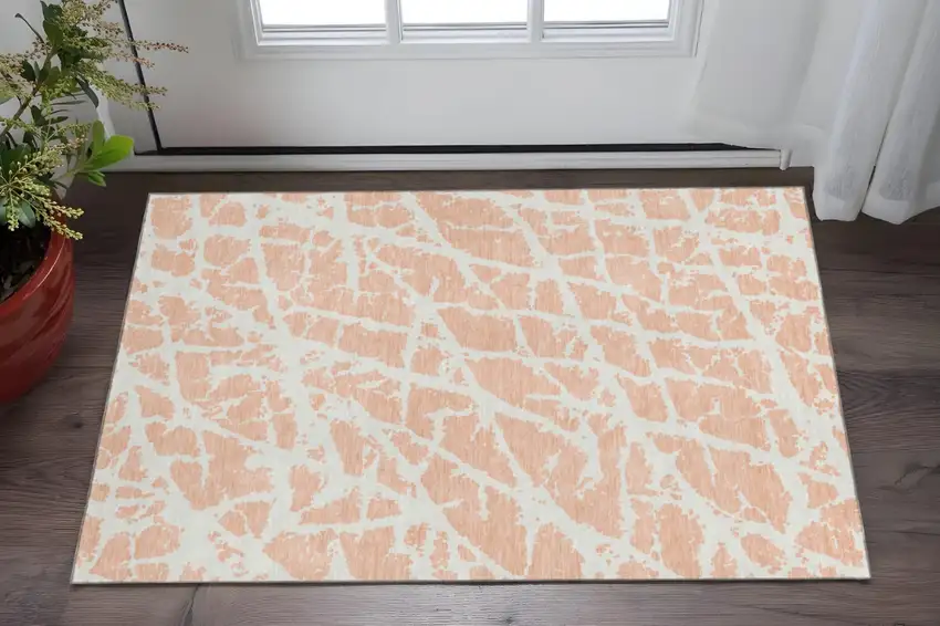 Peach And Ivory Abstract Washable Area Rug With UV Protection Photo 2