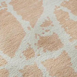 Photo of Peach And Ivory Abstract Washable Area Rug With UV Protection