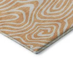 Photo of Peach And Ivory Abstract Washable Area Rug With UV Protection