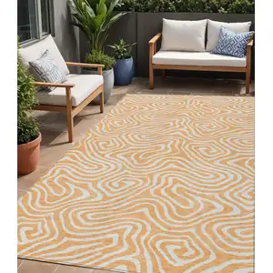 Photo of Peach And Ivory Abstract Washable Indoor Outdoor Area Rug