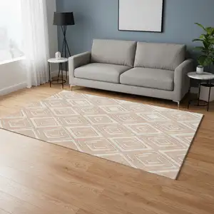 Photo of Peach And Ivory Geometric Washable Area Rug With UV Protection