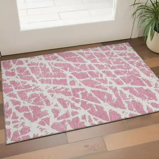 Pink And Ivory Abstract Washable Area Rug With UV Protection Photo 1
