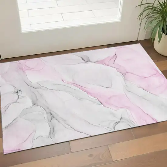 Pink And Ivory Abstract Washable Area Rug With UV Protection Photo 1
