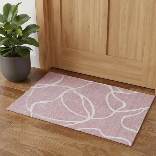 Pink And Ivory Abstract Washable Area Rug With UV Protection Photo 1