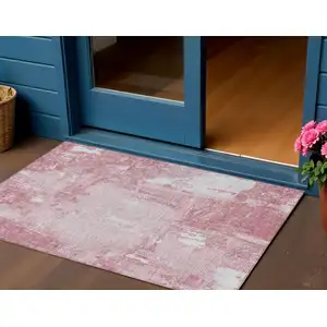 Photo of Pink And Ivory Abstract Washable Indoor Outdoor Area Rug
