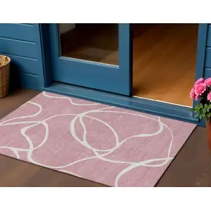 Photo of Pink And Ivory Abstract Washable Indoor Outdoor Area Rug