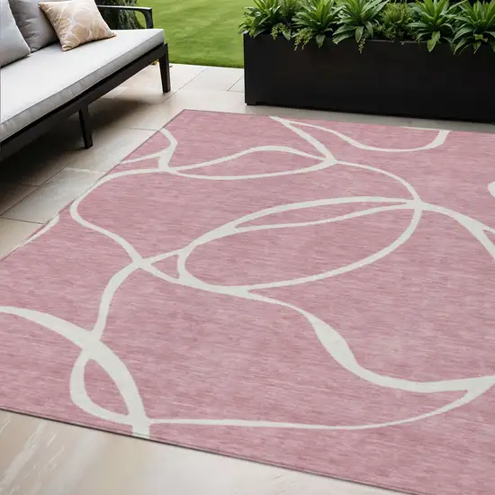 Pink And Ivory Abstract Washable Indoor Outdoor Area Rug Photo 1
