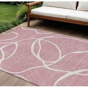 Photo of Pink And Ivory Abstract Washable Indoor Outdoor Area Rug