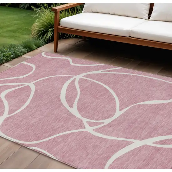 Pink And Ivory Abstract Washable Indoor Outdoor Area Rug Photo 1