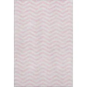 Photo of Pink And Ivory Chevron Washable Area Rug With UV Protection
