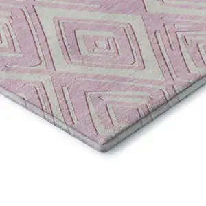 Photo of Pink And Ivory Geometric Washable Area Rug With UV Protection