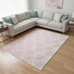 Photo of Pink And Ivory Geometric Washable Area Rug With UV Protection