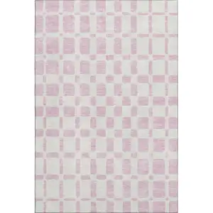 Photo of Pink And Ivory Geometric Washable Area Rug With UV Protection