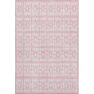 Photo of Pink And Ivory Geometric Washable Area Rug With UV Protection