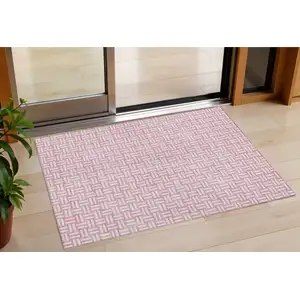 Photo of Pink And Ivory Geometric Washable Indoor Outdoor Area Rug