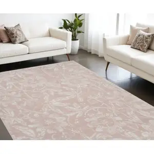 Photo of Pink And Ivory Tropical Floral Distressed Area Rug