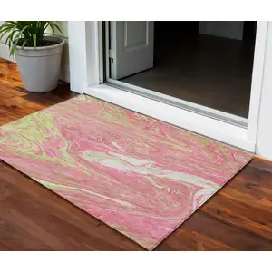 Photo of Pink Green And Ivory Abstract Washable Indoor Outdoor Area Rug