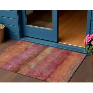 Photo of Pink Orange And Gold Abstract Washable Indoor Outdoor Area Rug