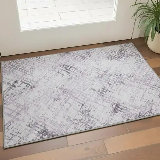 Purple And Ivory Abstract Geometric Washable Area Rug With UV Protection Photo 2