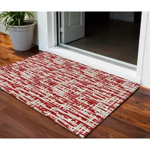 Photo of Red And Ivory Abstract Washable Indoor Outdoor Area Rug