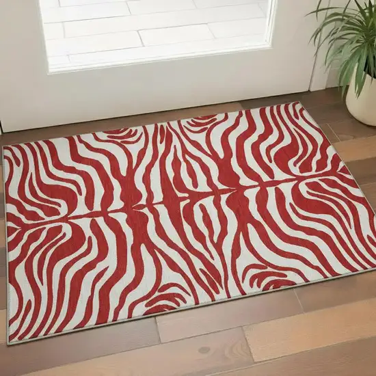 Red And Ivory Animal Print Washable Area Rug With UV Protection Photo 2