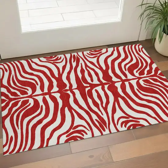 Red And Ivory Animal Print Washable Area Rug With UV Protection Photo 1