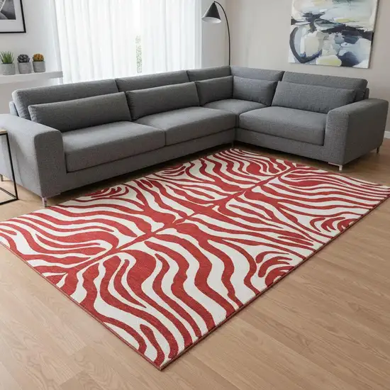 Red And Ivory Animal Print Washable Area Rug With UV Protection Photo 2