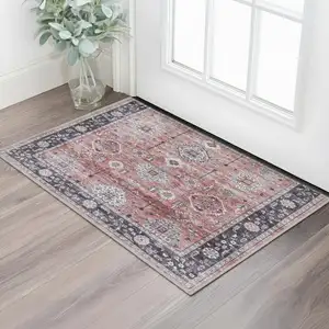 Photo of Red Black And Ivory Oriental Distressed Area Rug