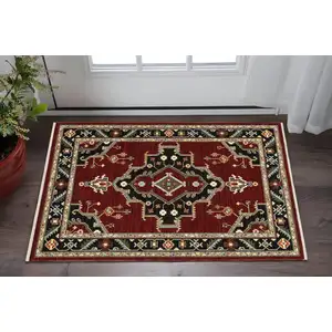 Photo of Red Black Beige And Blue Oriental Power Loom Stain Resistant Area Rug With Fringe