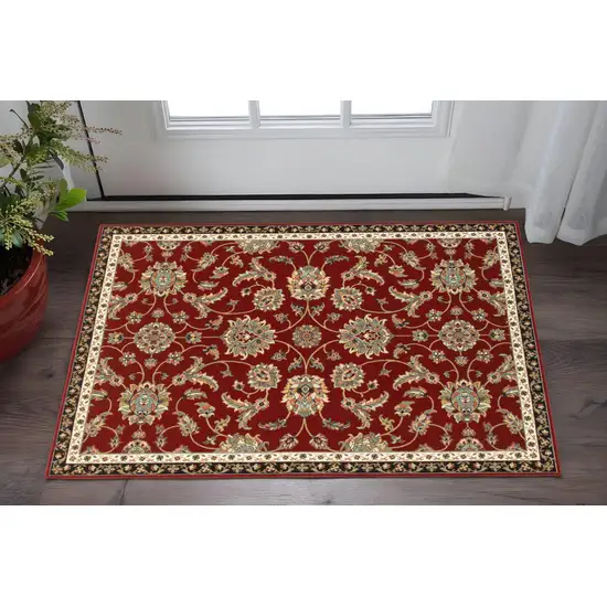 2' X 4' Red Black Blue Ivory Green And Salmon Oriental Power Loom Stain Resistant Area Rug Photo 1