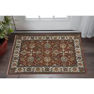 Photo of Red Blue Ivory Gold And Navy Oriental Power Loom Stain Resistant Area Rug With Fringe