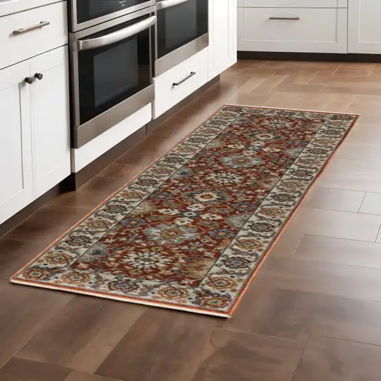 2' X 8' Red Blue Ivory Gold And Navy Oriental Power Loom Stain Resistant Runner Rug With Fringe Photo 1