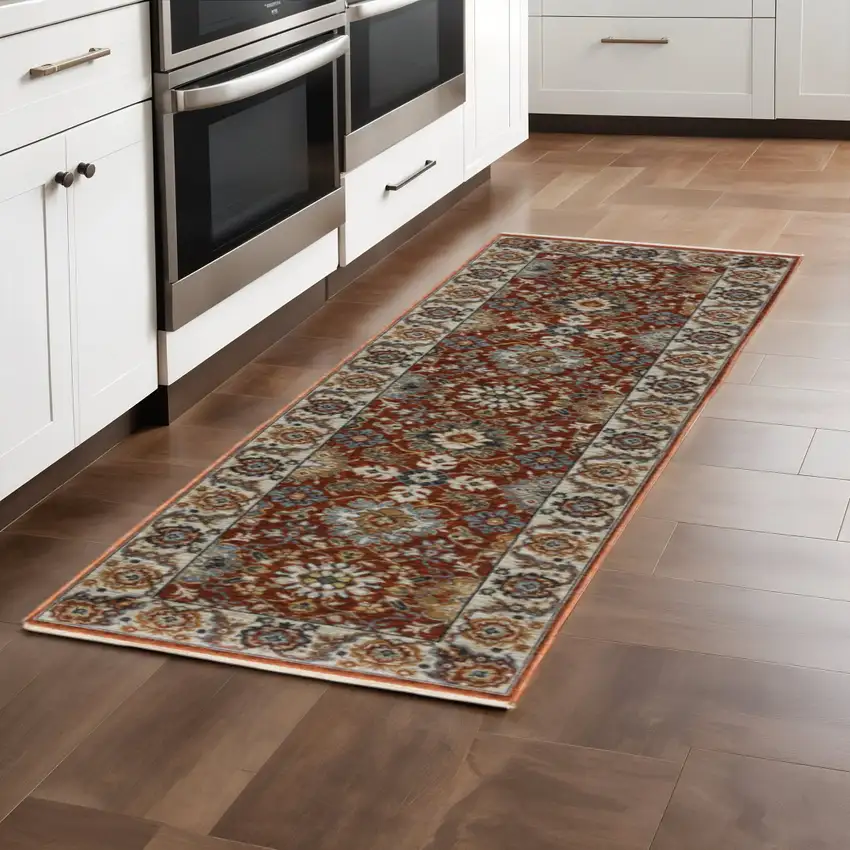 2' X 8' Red Blue Ivory Gold And Navy Oriental Power Loom Stain Resistant Runner Rug With Fringe Photo 1