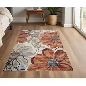 Photo of Red and Beige Floral Distressed Area Rug