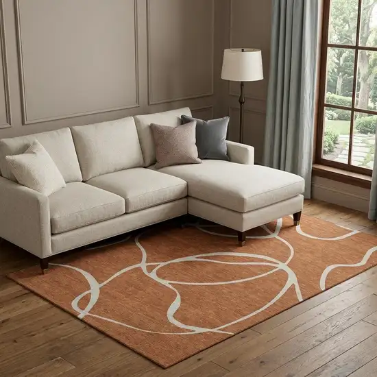 Rust And Beige Abstract Washable Area Rug With UV Protection Photo 1