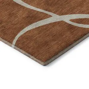 Photo of Rust And Beige Abstract Washable Area Rug With UV Protection