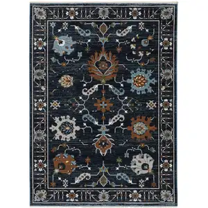 Photo of Rust And Black Oriental Area Rug With Fringe