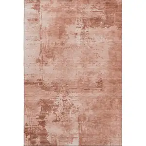 Photo of Rust And Coral Abstract Washable Area Rug With UV Protection