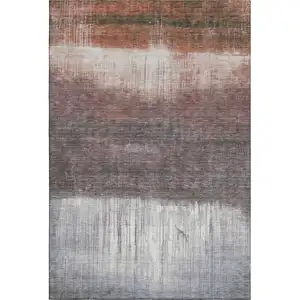 Photo of Rust And Ivory Abstract Washable Area Rug With UV Protection