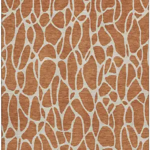 Photo of Rust And Ivory Geometric Washable Area Rug With UV Protection
